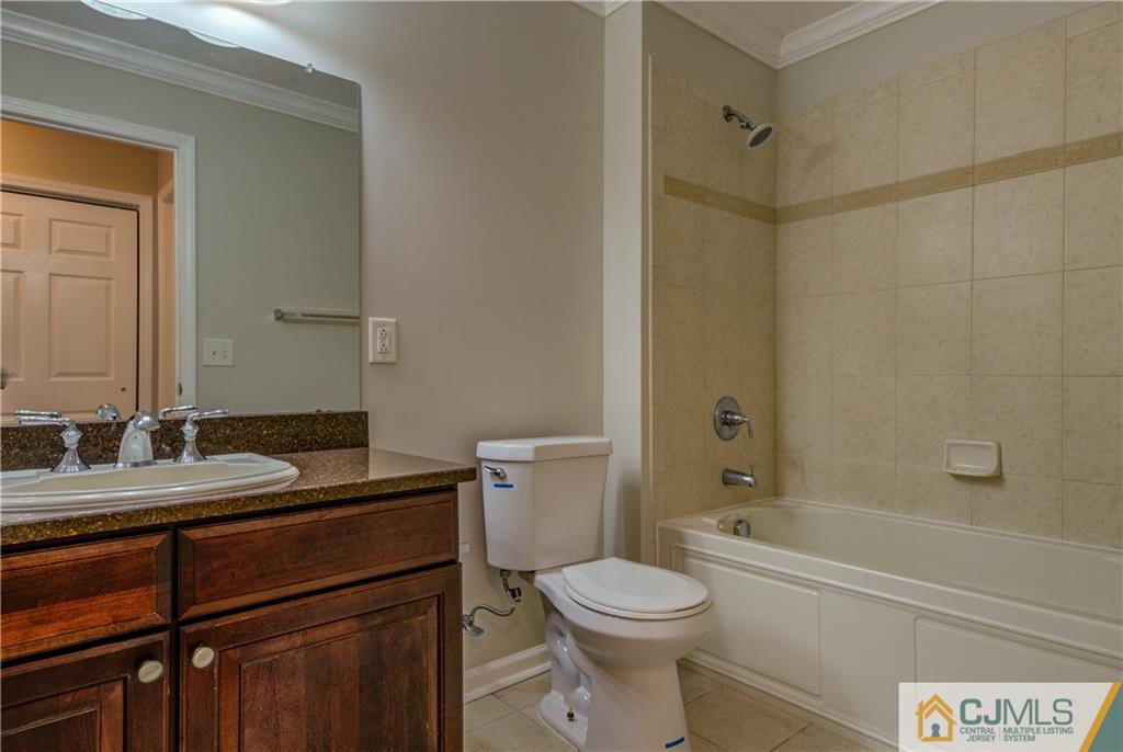 358 Rector Street, Unit 607 Perth Amboy, NJ 08861 - Photo 21 of 25 a bathroom with a granite countertop sink toilet and shower