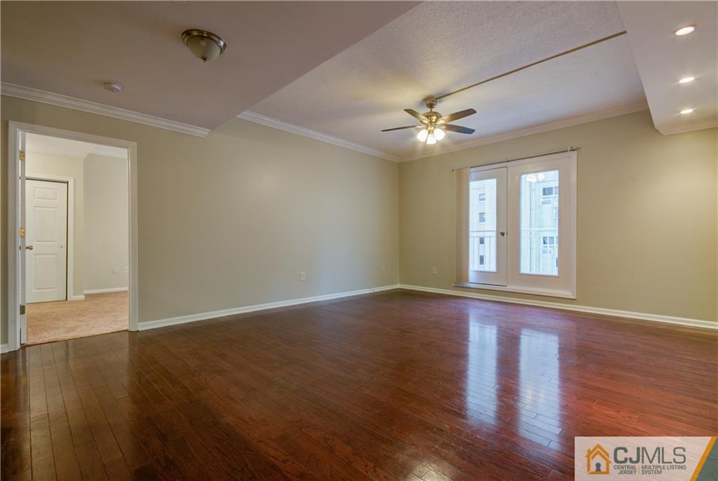 358 Rector Street, Unit 607 Perth Amboy, NJ 08861 - Photo 5 of 25 a view of an empty room with window and wooden floor