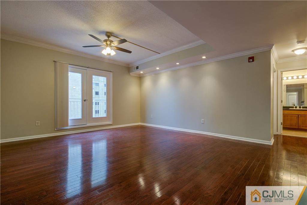 358 Rector Street, Unit 607 Perth Amboy, NJ 08861 - Photo 6 of 25 a view of an empty room with window and wooden floor