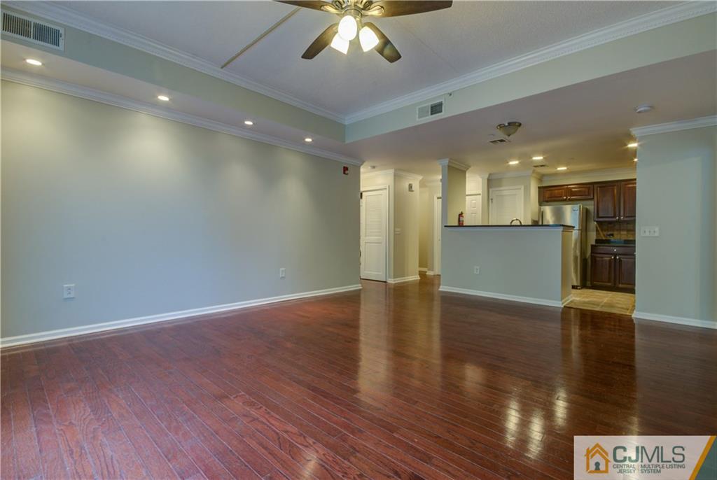 358 Rector Street, Unit 607 Perth Amboy, NJ 08861 - Photo 7 of 25 a view of a big room with wooden floor and a kitchen