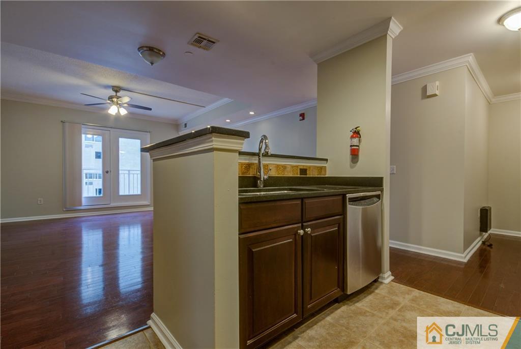 358 Rector Street, Unit 607 Perth Amboy, NJ 08861 - Photo 10 of 25 a kitchen with a refrigerator and cabinets