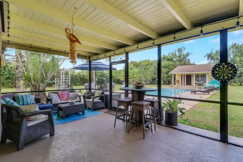 a room with pool table and windows