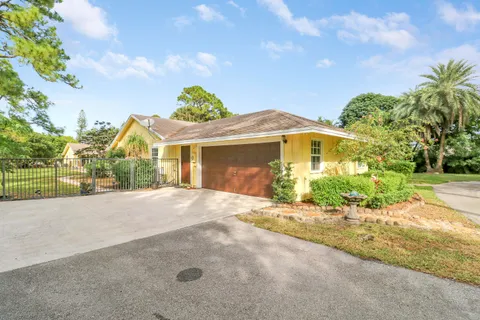 a view of a house with a yard and tree s