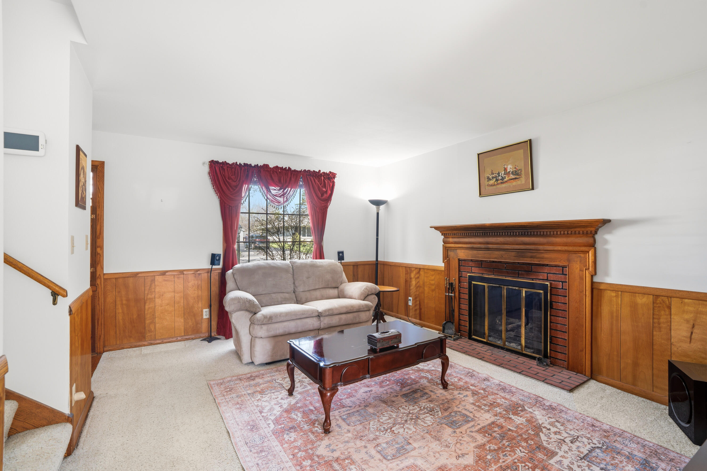 4133 Lexington Avenue Caledonia, WI 53404 - Photo 23 of 42 Den with fireplace - small rust stain under area rug