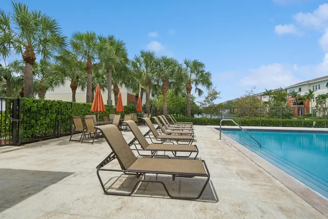a view of swimming pool with outdoor seating and plants