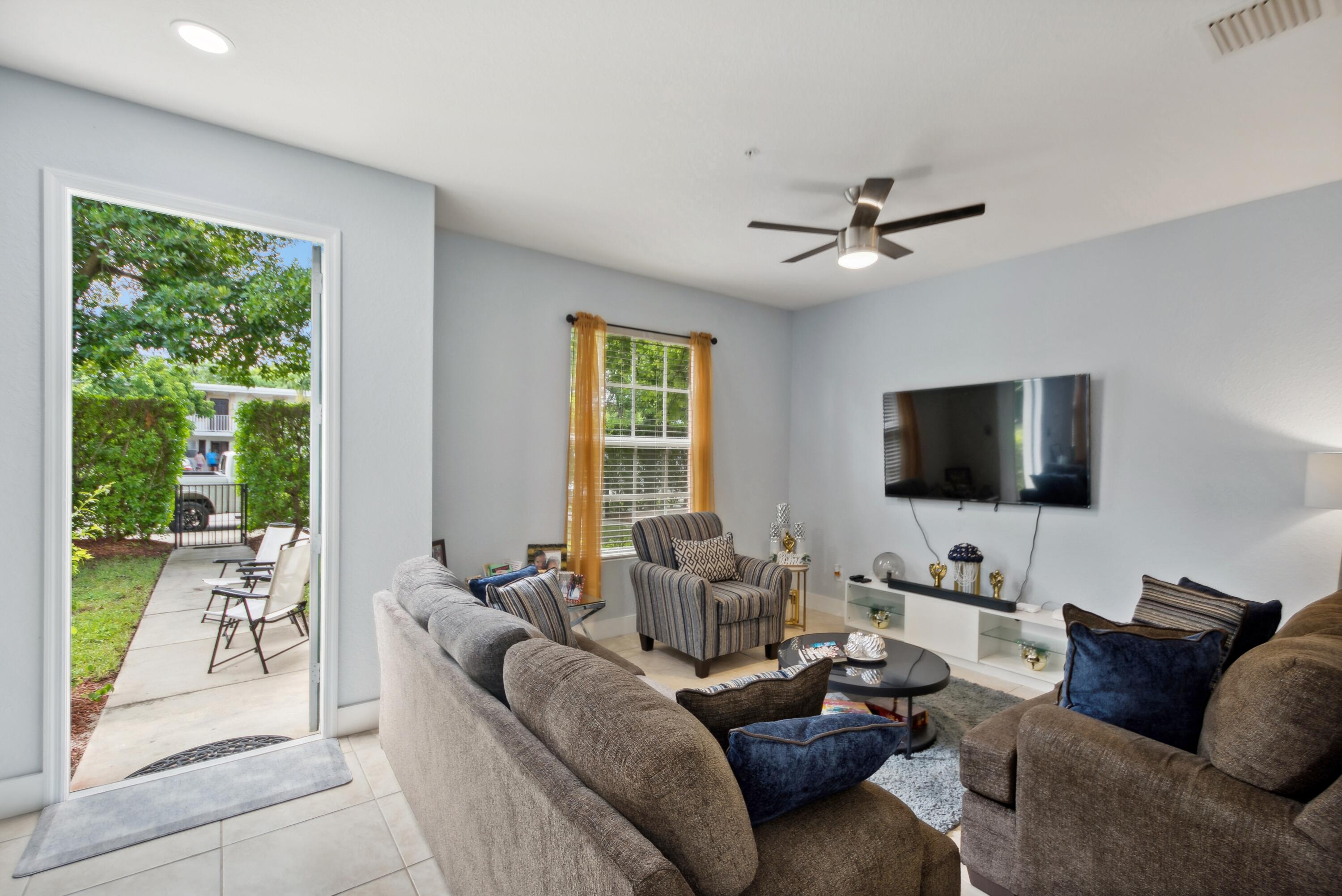 148 Southwest 7th Court Pompano Beach, FL 33060 - Photo 3 of 19 a living room with furniture and a flat screen tv