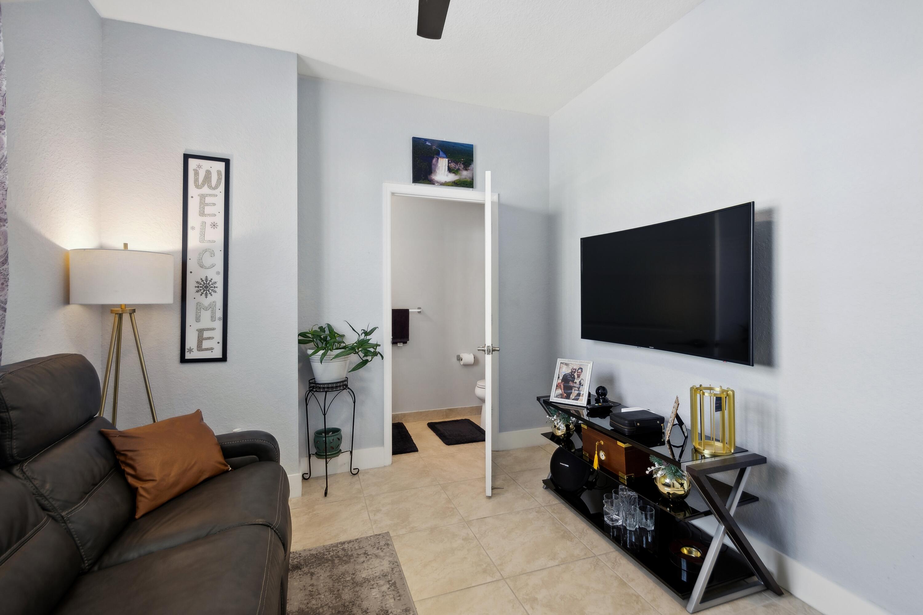 148 Southwest 7th Court Pompano Beach, FL 33060 - Photo 7 of 19 a living room with furniture and a flat screen tv