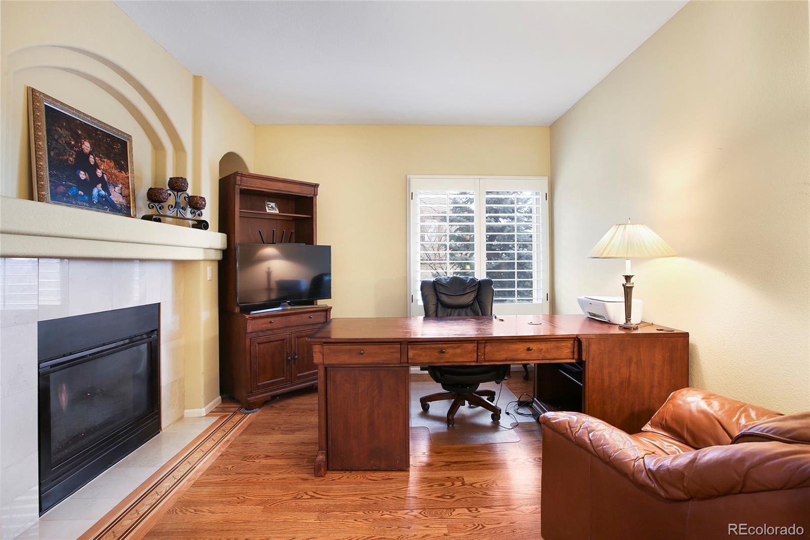 7768 Edgewater Court Lone Tree, CO 80124 - Photo 15 of 39 a work room with furniture a fireplace and a window