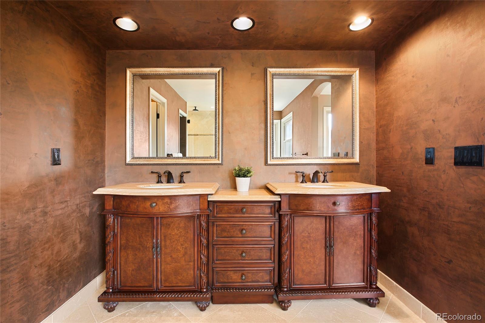 7768 Edgewater Court Lone Tree, CO 80124 - Photo 18 of 39 a bathroom with a sink mirror and a bathtub