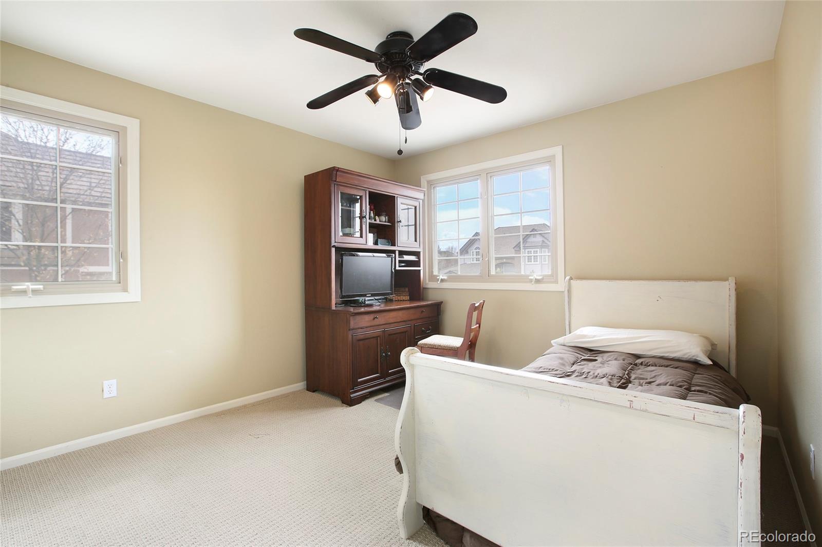 7768 Edgewater Court Lone Tree, CO 80124 - Photo 23 of 39 a living room with stainless steel appliances furniture and a chandelier