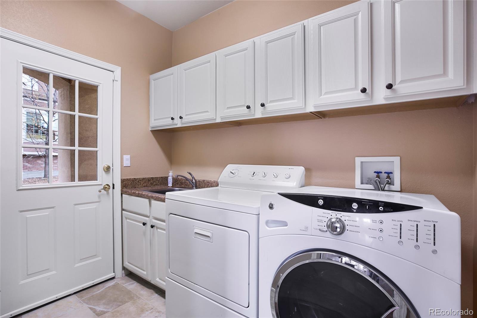 7768 Edgewater Court Lone Tree, CO 80124 - Photo 24 of 39 a utility room with dryer and washer