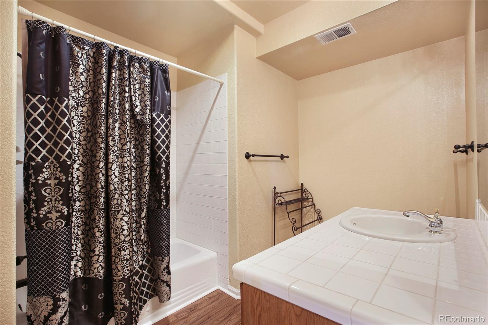 7768 Edgewater Court Lone Tree, CO 80124 - Photo 25 of 39 a bathroom with a bathtub and shower