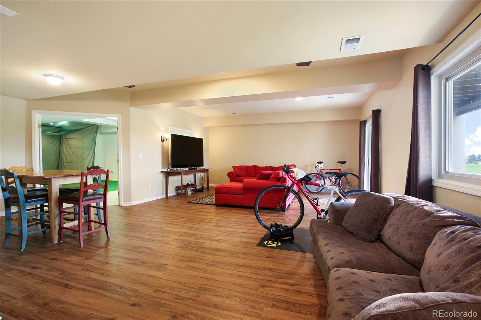 7768 Edgewater Court Lone Tree, CO 80124 - Photo 26 of 39 a living room with furniture and a flat screen tv