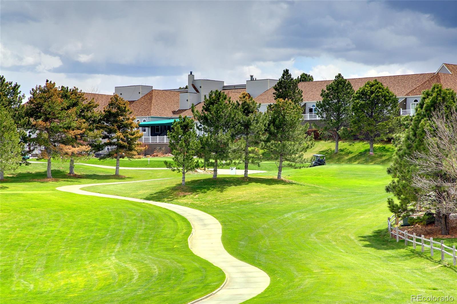 7768 Edgewater Court Lone Tree, CO 80124 - Photo 37 of 39 a swimming pool with lots of trees in the background