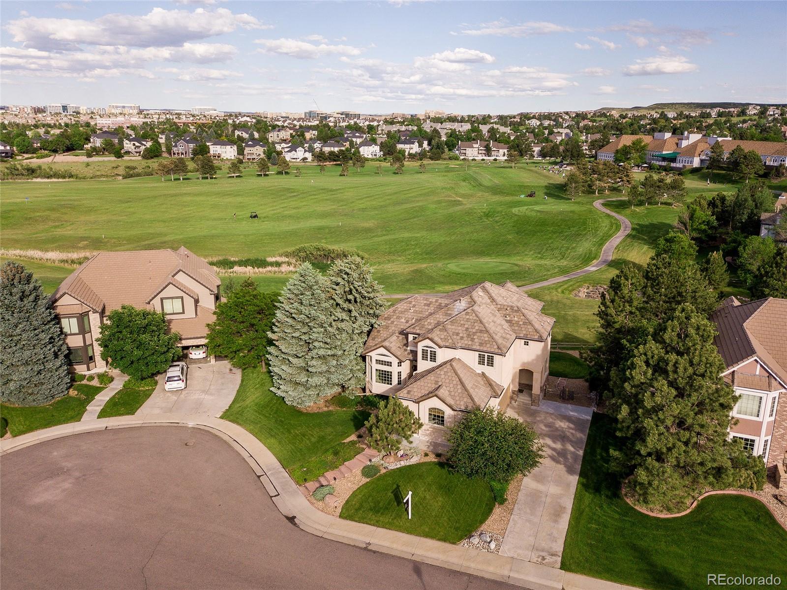 7768 Edgewater Court Lone Tree, CO 80124 - Photo 39 of 39 an aerial view of a house with a garden and lake view