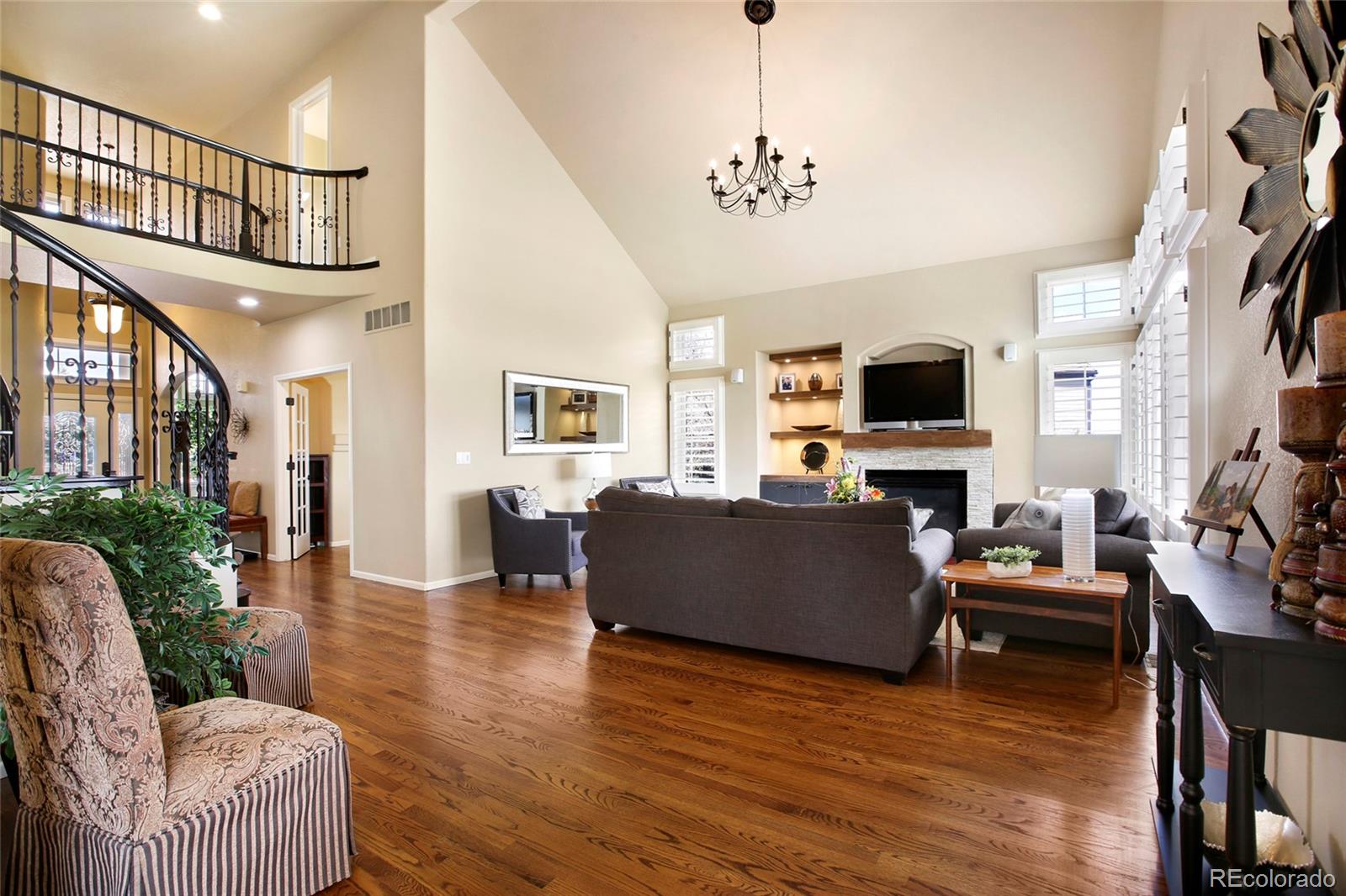 7768 Edgewater Court Lone Tree, CO 80124 - Photo 5 of 39 a living room with furniture and a flat screen tv