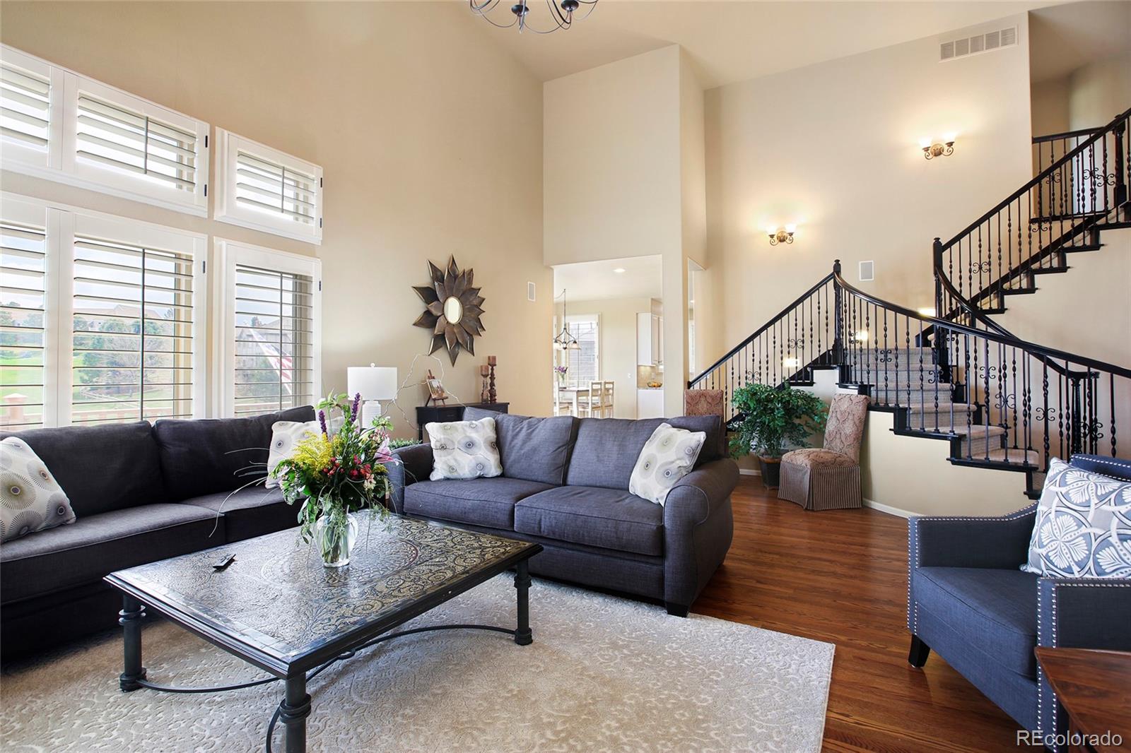 7768 Edgewater Court Lone Tree, CO 80124 - Photo 7 of 39 a living room with furniture potted plant and wooden floor
