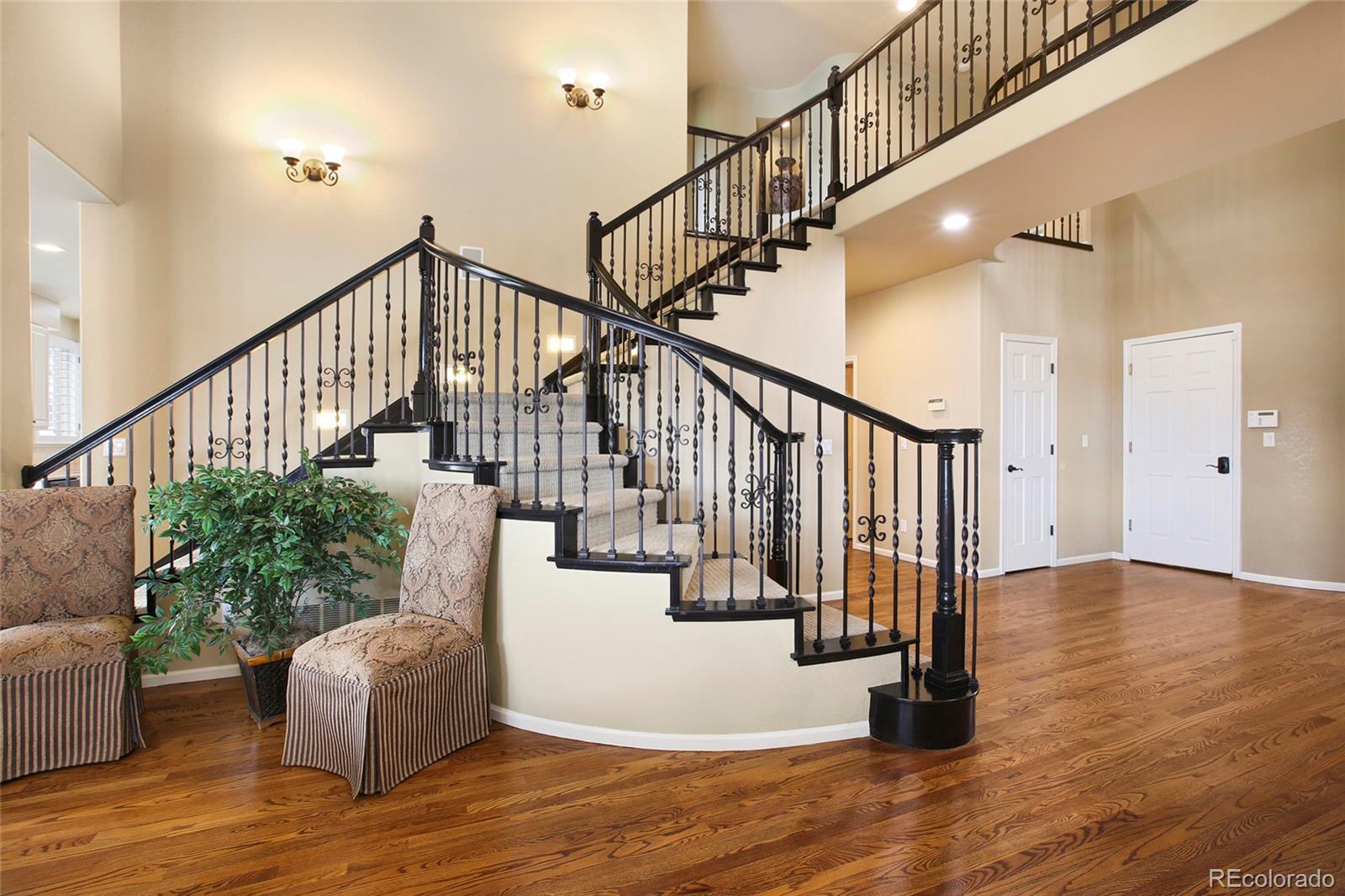 7768 Edgewater Court Lone Tree, CO 80124 - Photo 9 of 39 a view of entryway and hall with wooden floor