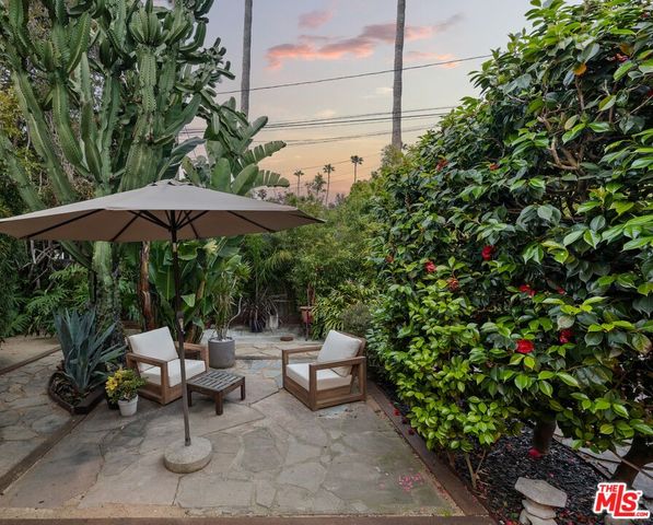 a backyard of a house with table and chairs