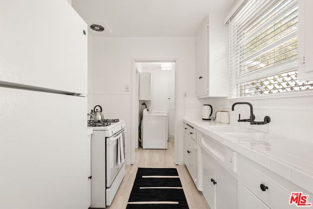 a kitchen with a sink and a stove