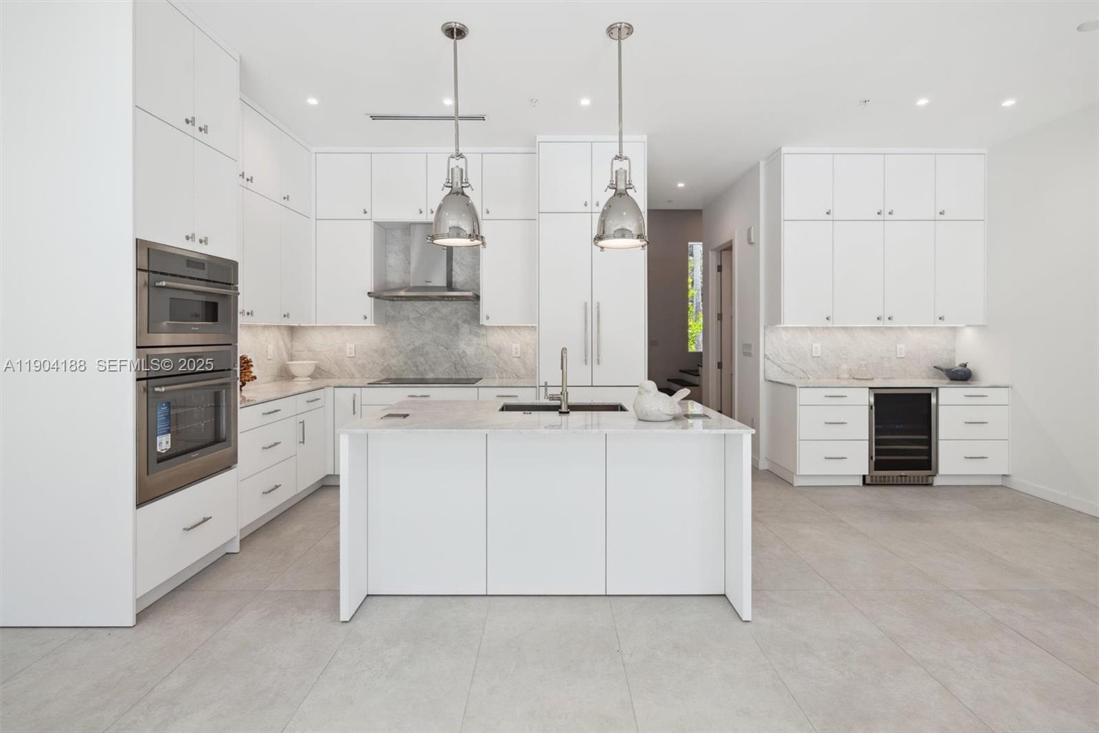 554 North Riverside Drive, Unit B Pompano Beach, FL 33062 - Photo 12 of 48 a large kitchen with cabinets and stainless steel appliances