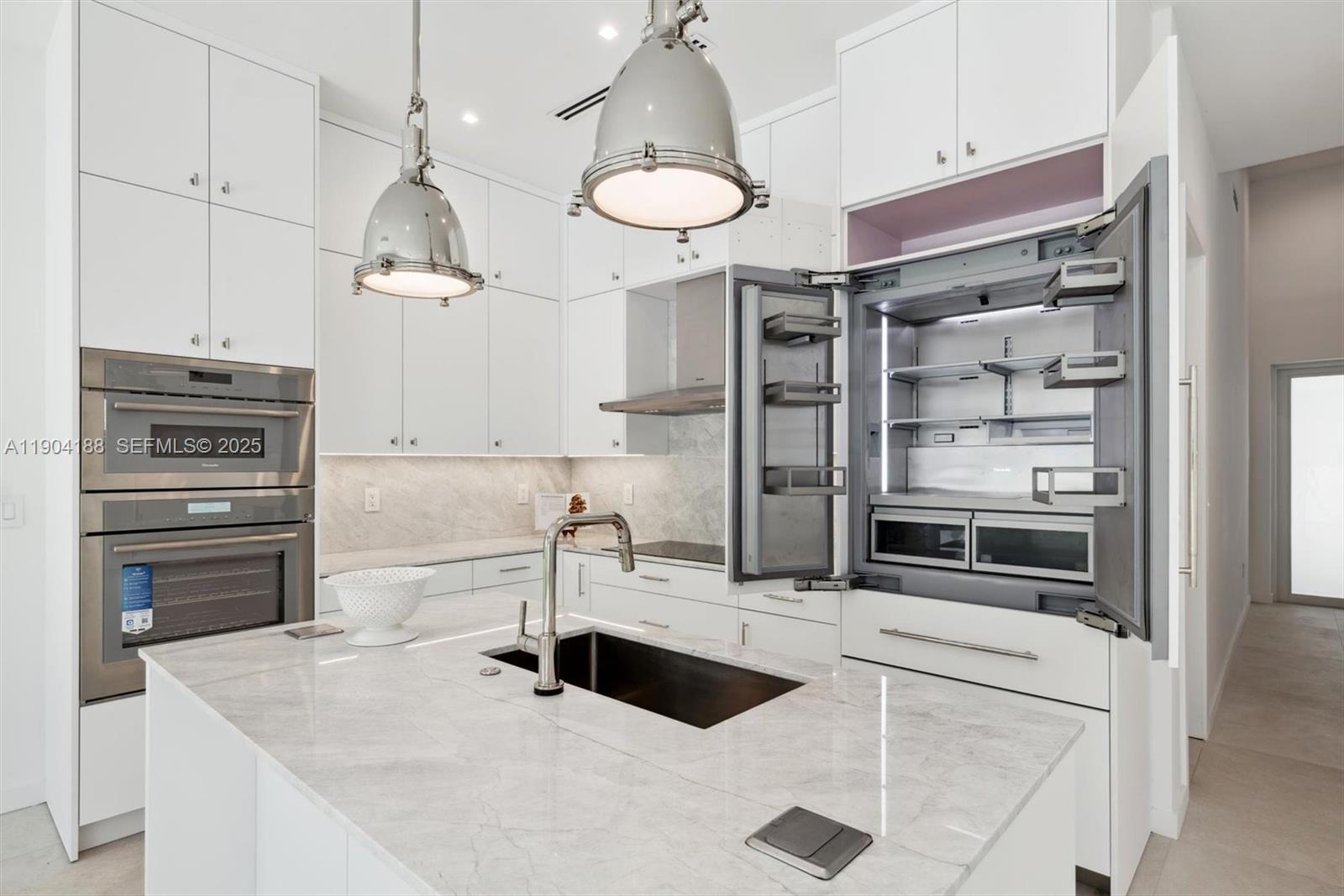 554 North Riverside Drive, Unit B Pompano Beach, FL 33062 - Photo 16 of 48 a kitchen with a refrigerator and a sink