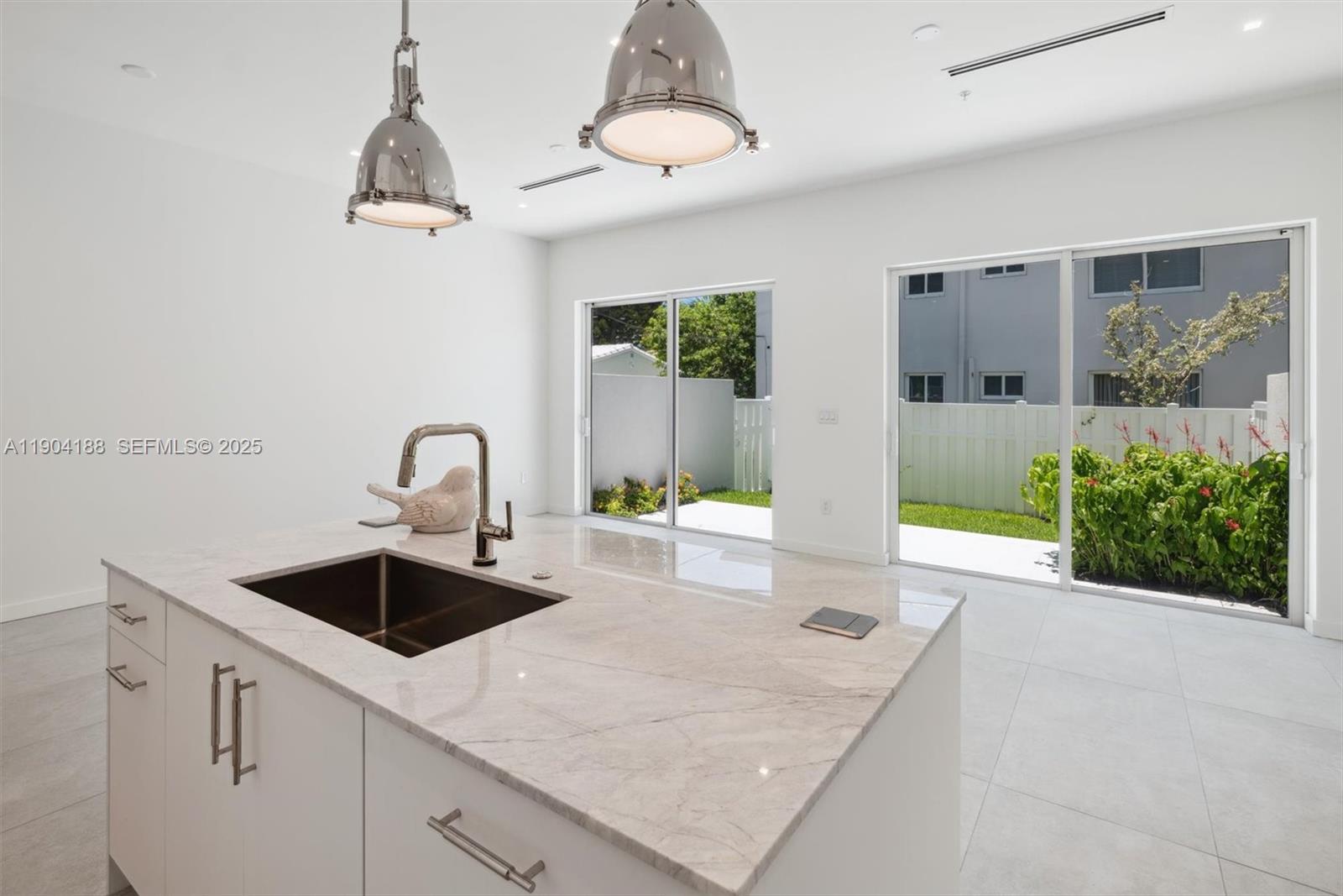 554 North Riverside Drive, Unit B Pompano Beach, FL 33062 - Photo 17 of 48 a kitchen with a sink a counter and chairs