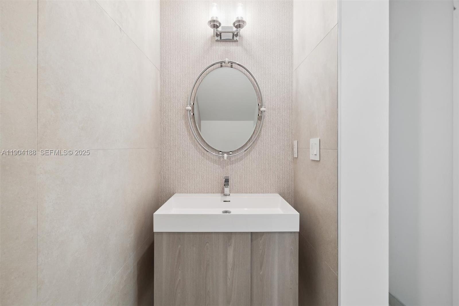 554 North Riverside Drive, Unit B Pompano Beach, FL 33062 - Photo 23 of 48 a bathroom with a sink and a mirror