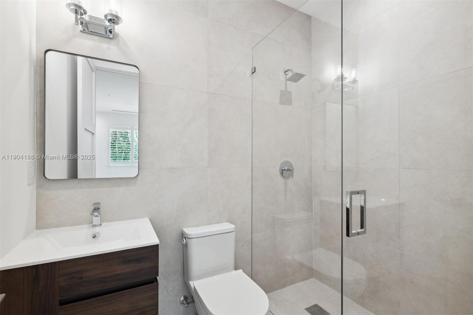 554 North Riverside Drive, Unit B Pompano Beach, FL 33062 - Photo 32 of 48 a bathroom with a toilet a sink shower and mirror