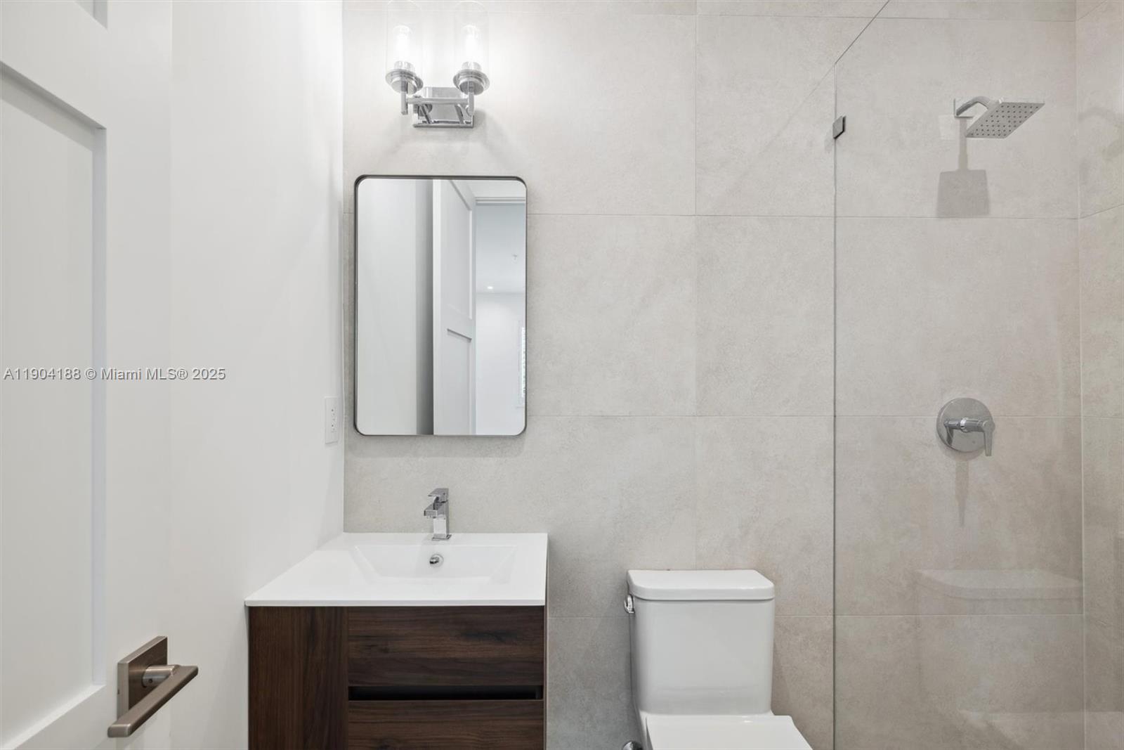 554 North Riverside Drive, Unit B Pompano Beach, FL 33062 - Photo 33 of 48 a bathroom with a sink a toilet and shower