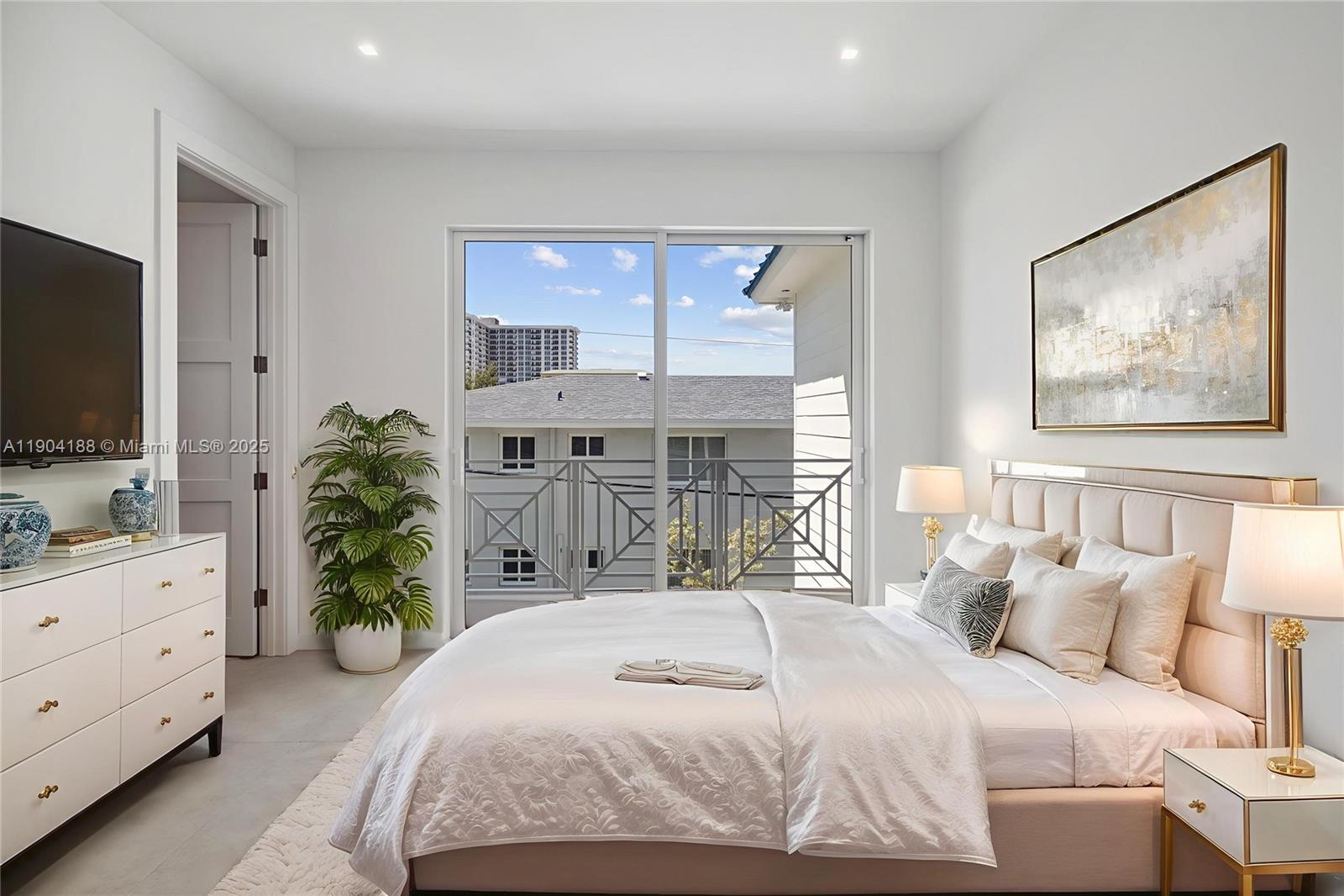 554 North Riverside Drive, Unit B Pompano Beach, FL 33062 - Photo 37 of 48 a bedroom with a bed and a flat screen tv