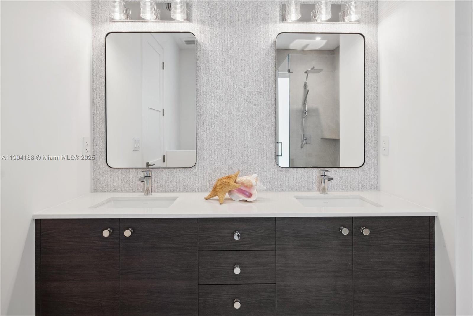 554 North Riverside Drive, Unit B Pompano Beach, FL 33062 - Photo 41 of 48 a bathroom with a double vanity sink and mirror