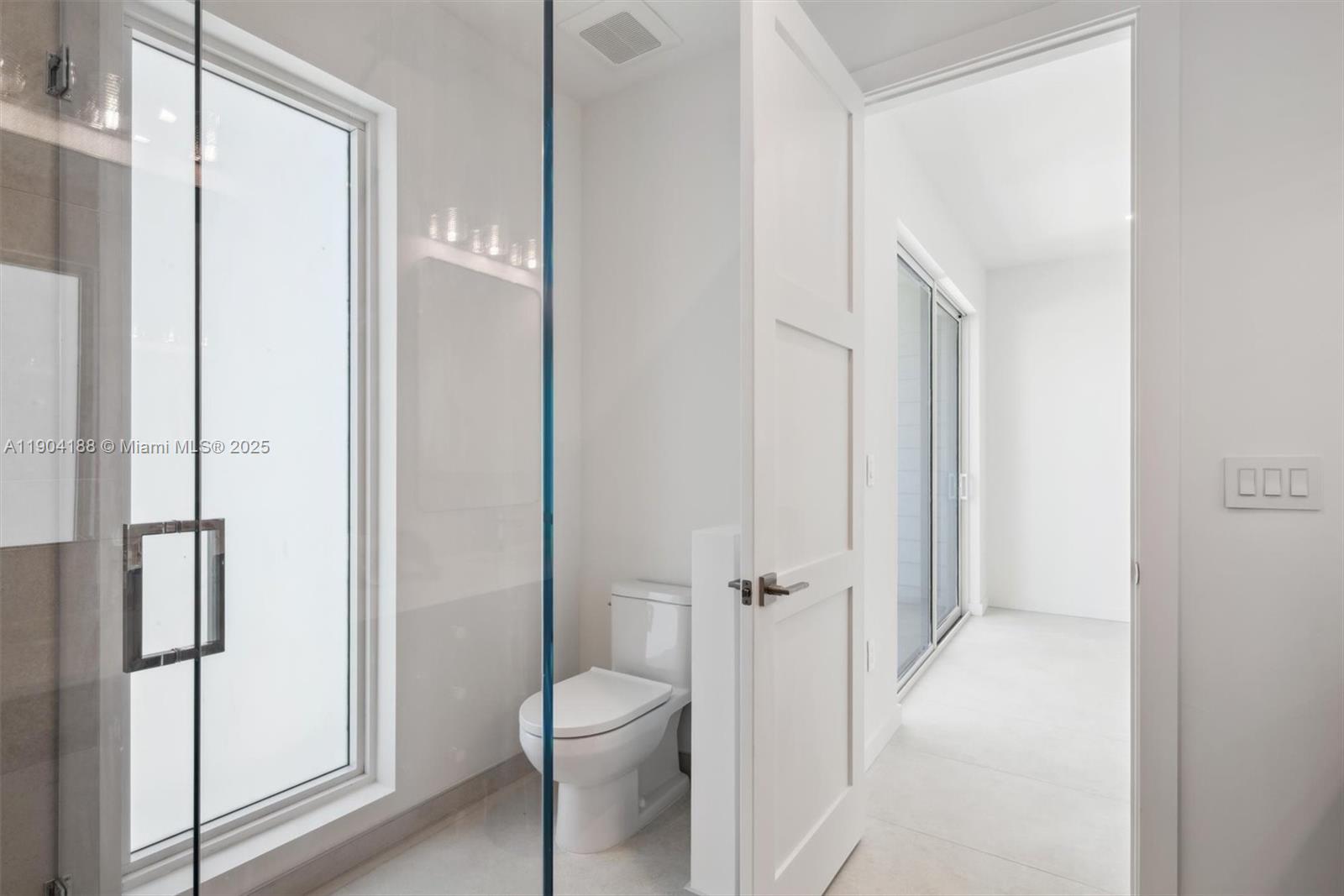 554 North Riverside Drive, Unit B Pompano Beach, FL 33062 - Photo 42 of 48 a bathroom with a granite countertop shower and a toilet