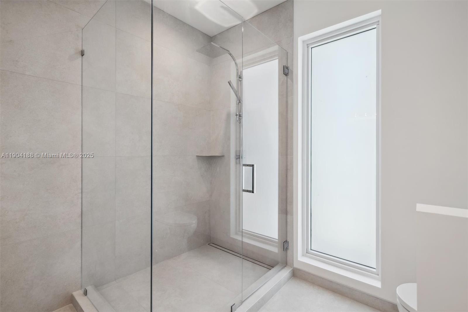 554 North Riverside Drive, Unit B Pompano Beach, FL 33062 - Photo 43 of 48 a bathroom with a shower and a glass door