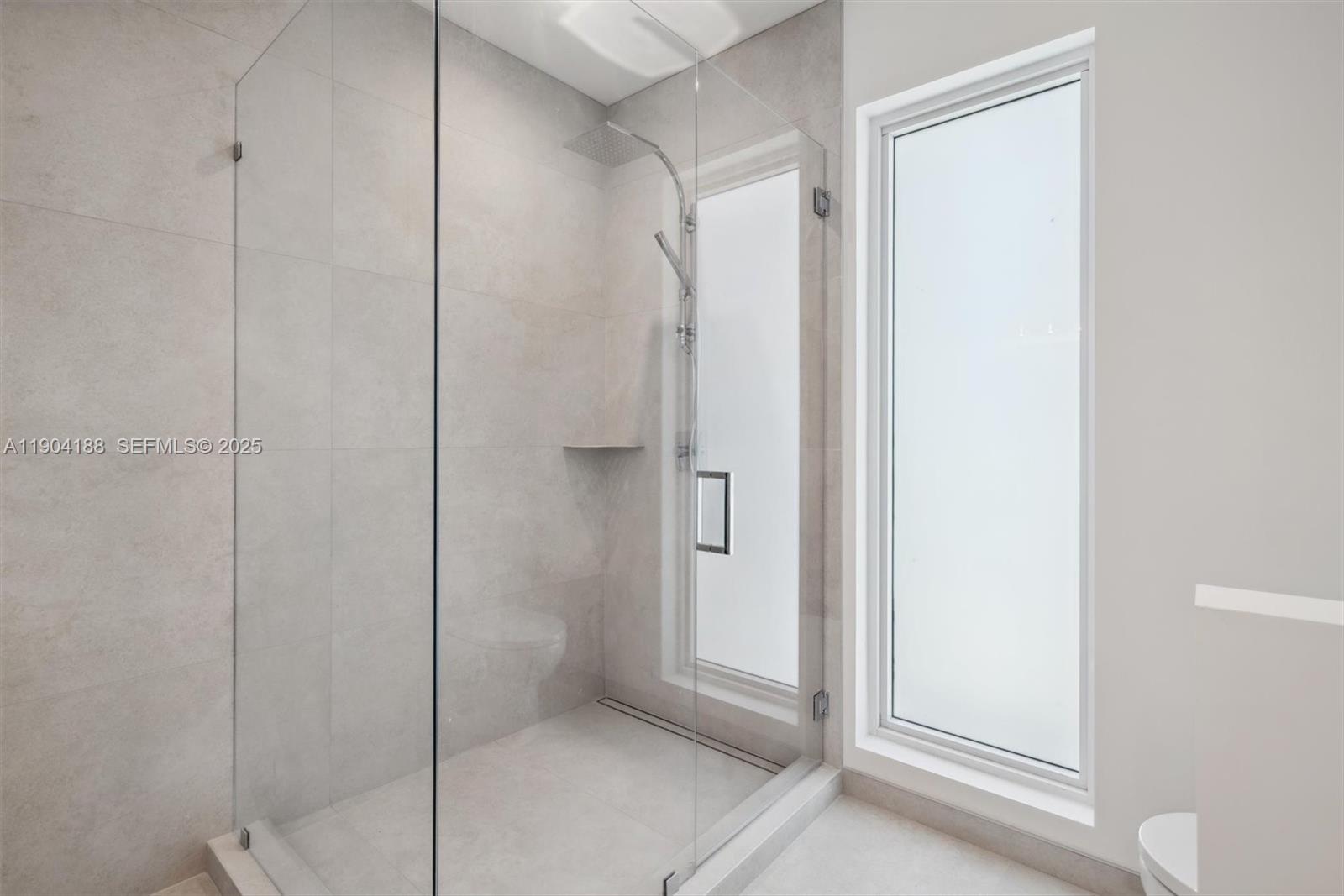 554 North Riverside Drive, Unit B Pompano Beach, FL 33062 - Photo 43 of 48 a bathroom with a shower and a glass door