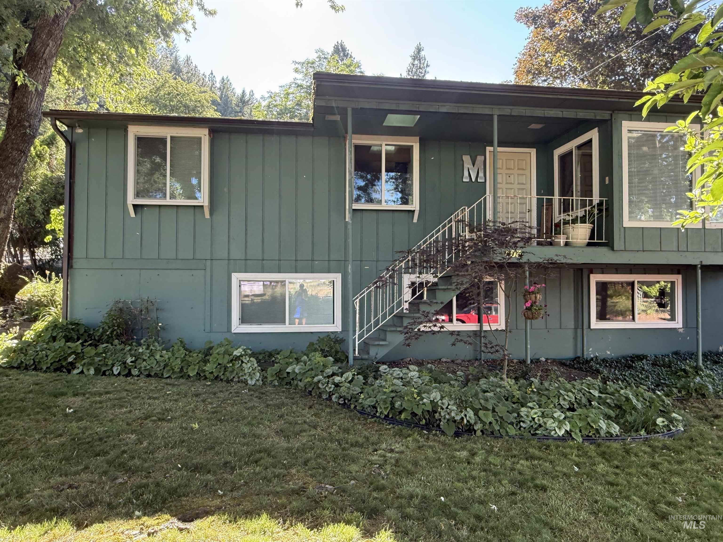403 138th Street Orofino, ID 83544 - Photo 3 of 32 View of front of house featuring board and batten siding, a front lawn, and stairs