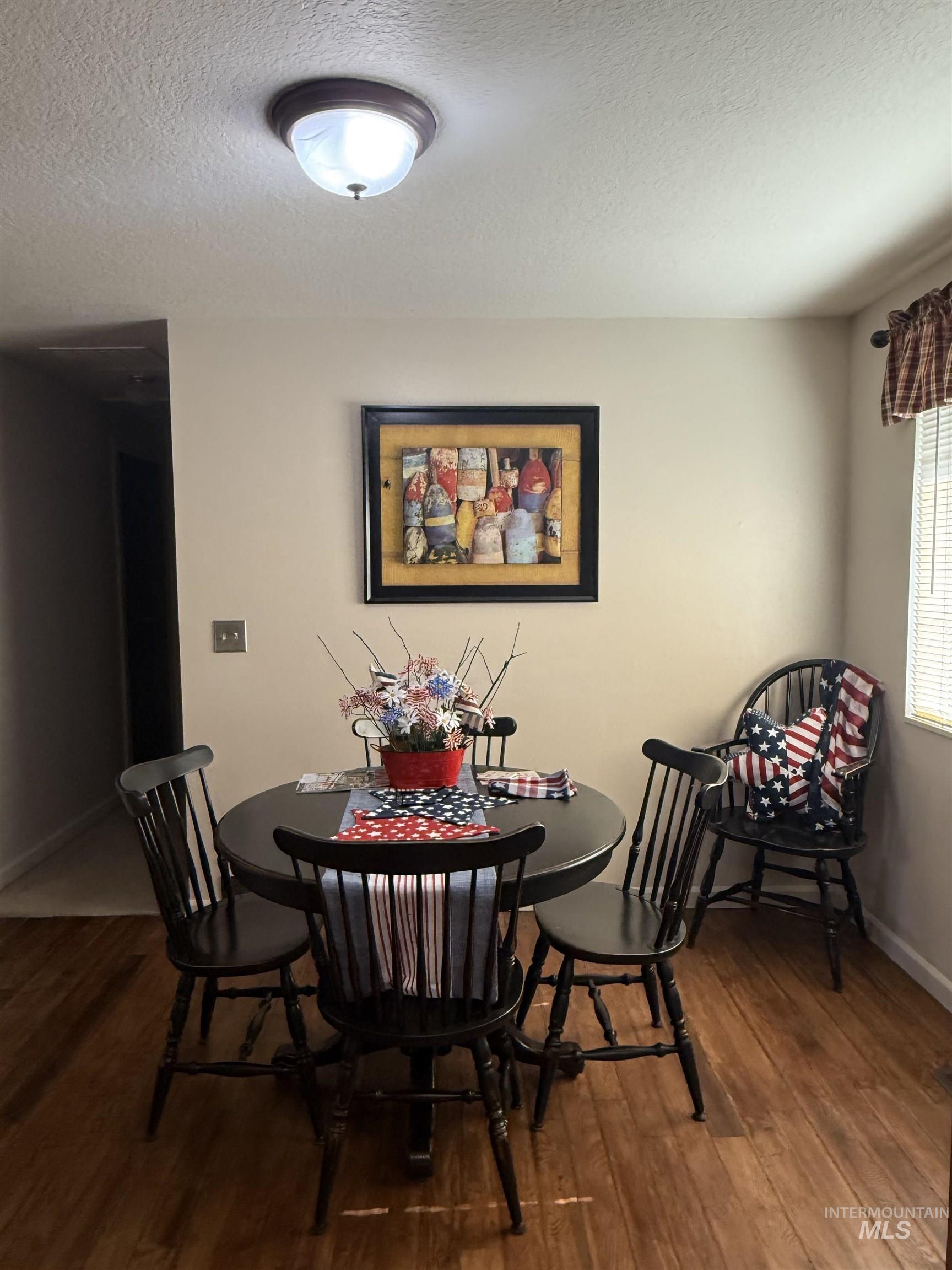 403 138th Street Orofino, ID 83544 - Photo 9 of 32 Dining space featuring wood finished floors and a textured ceiling