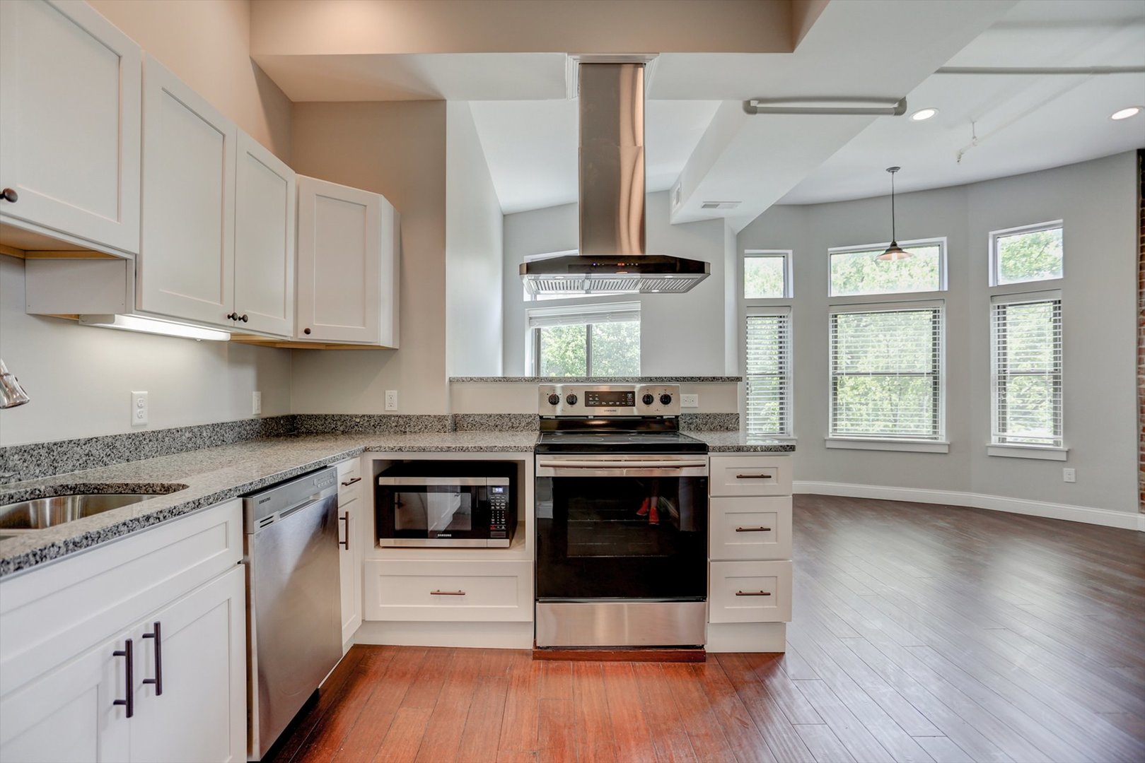 218 West Main Street Urbana, IL 61801 - Photo 12 of 96 a kitchen with stainless steel appliances white cabinets and wooden floor