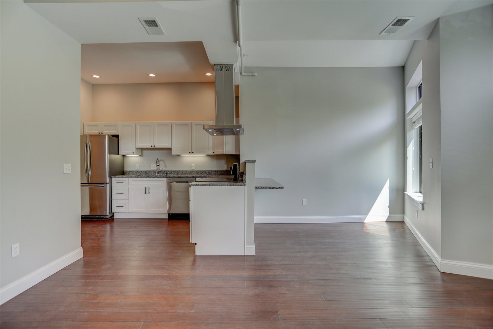 218 West Main Street Urbana, IL 61801 - Photo 16 of 96 a view of a kitchen with a sink and dishwasher with wooden floor