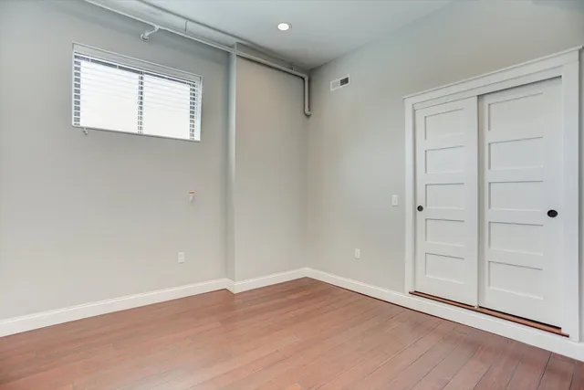 a kitchen with granite countertop white cabinets and stainless steel appliances