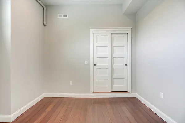 a view of a kitchen with a sink and wooden floor