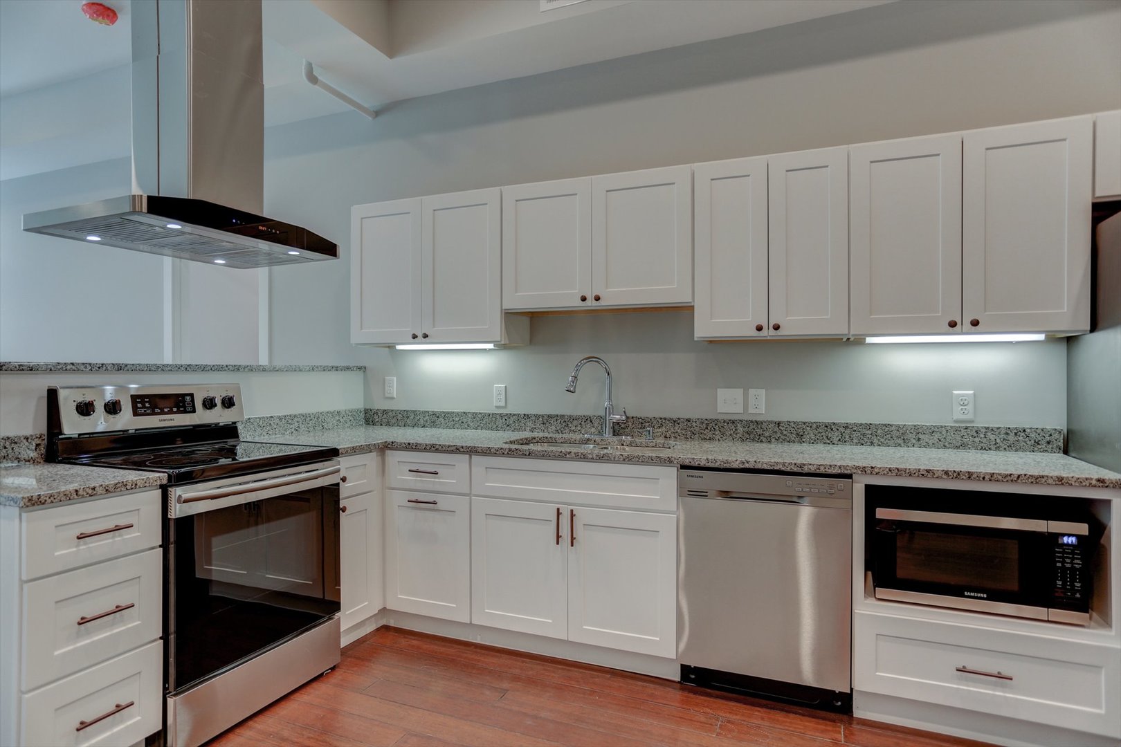 218 West Main Street Urbana, IL 61801 - Photo 28 of 96 a kitchen with granite countertop white cabinets and stainless steel appliances