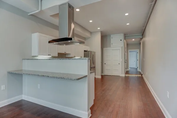 a kitchen with granite countertop a sink and stainless steel appliances