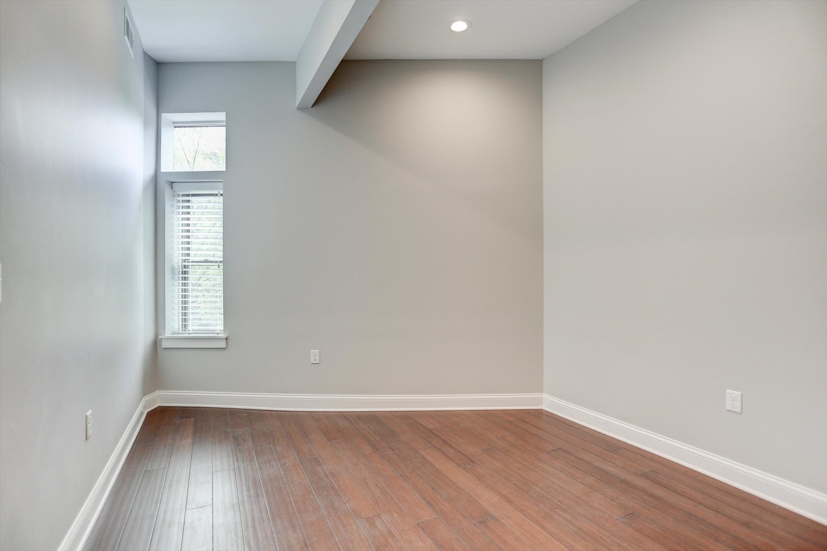 218 West Main Street Urbana, IL 61801 - Photo 32 of 96 an empty room with wooden floor and windows