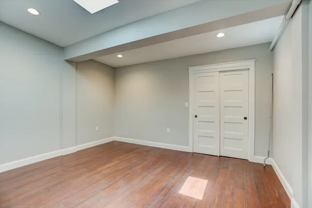 wooden floor in an empty room with a window