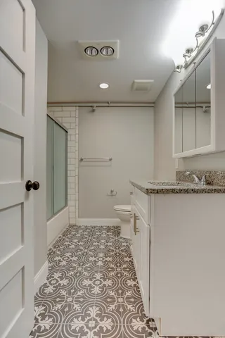 a utility room with wooden floor washer and dryer