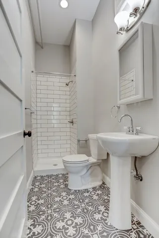 a bathroom with a granite countertop toilet a sink and a mirror