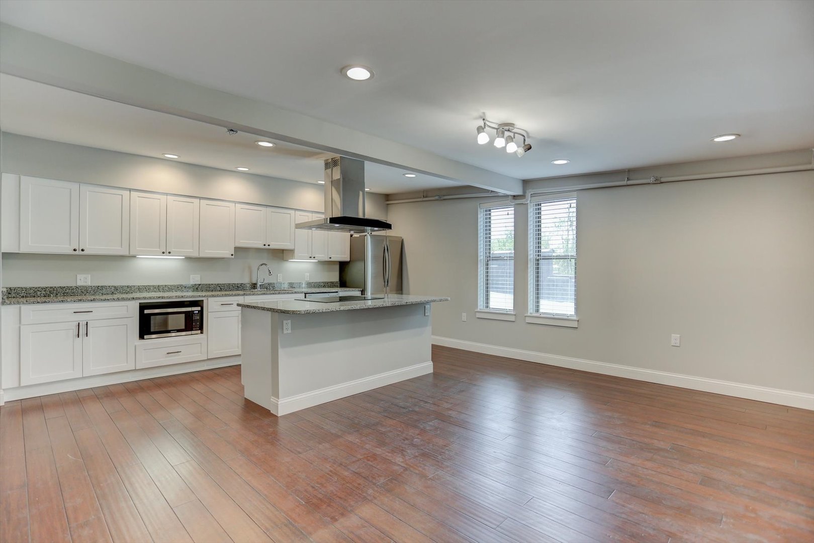 218 West Main Street Urbana, IL 61801 - Photo 43 of 96 a large kitchen with stainless steel appliances a large counter top a sink a stove and cabinets