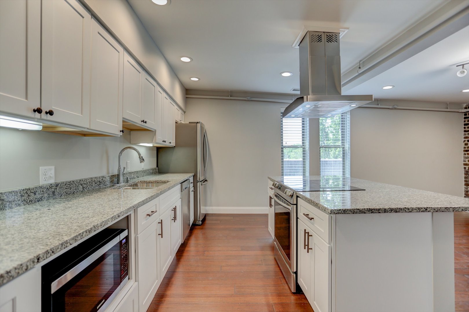218 West Main Street Urbana, IL 61801 - Photo 45 of 96 a kitchen with granite countertop a sink and stainless steel appliances