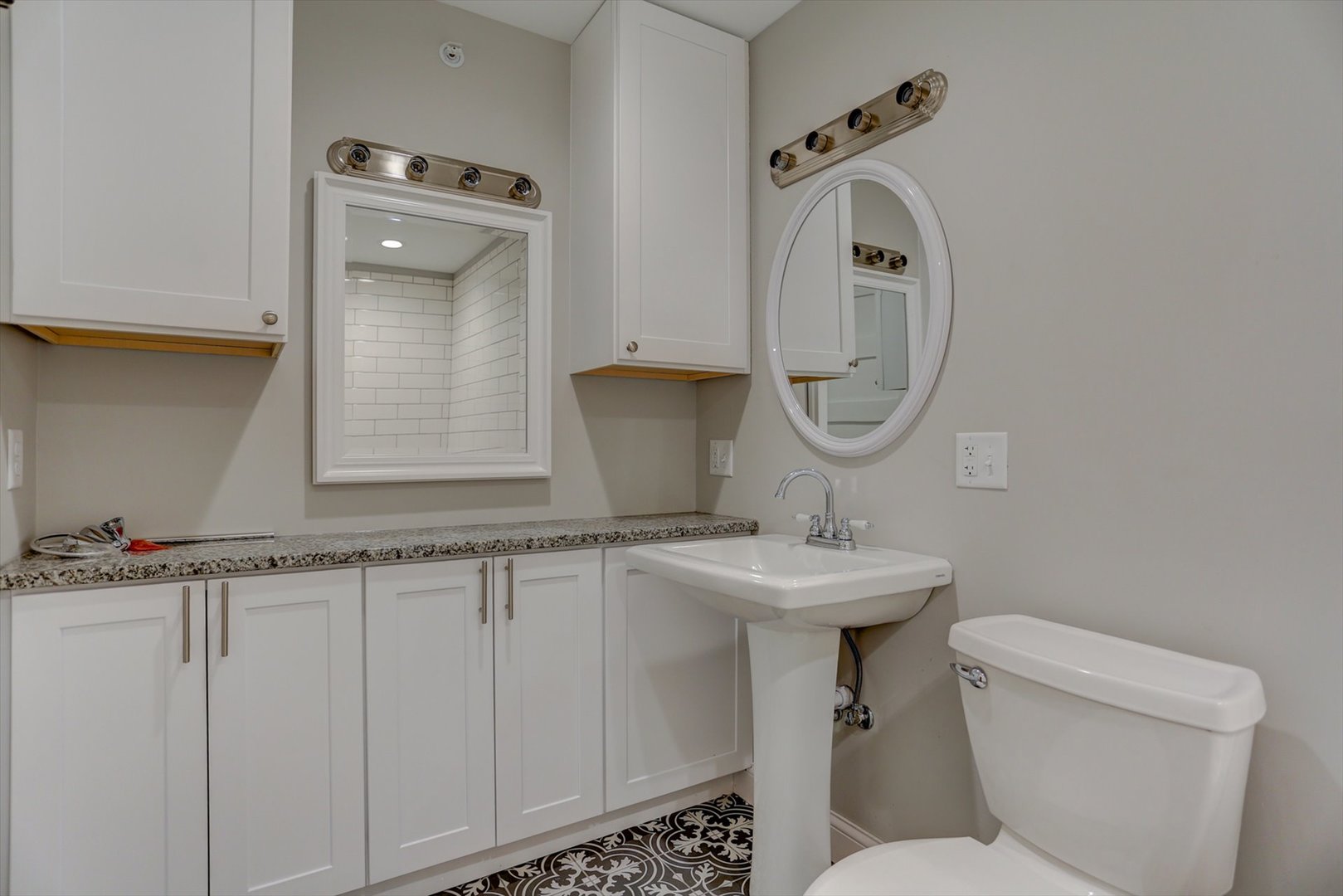 218 West Main Street Urbana, IL 61801 - Photo 57 of 96 a bathroom with a toilet sink and mirror